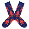 These colorful navy cotton men's crew socks by the brand Socksmith feature bright orange Octopus in a repeated pattern on the foot and leg.