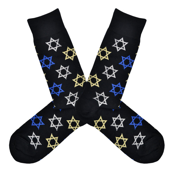 Shown in a flatlay, a pair of men's Socksmith brand cotton crew socks in dark blue with blue, white, and yellow Stars of David all over the sock.