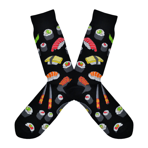 Shown in a flatlay, a pair of Socksmith's black cotton men's crew socks with various types of sushi rolls and chopsticks in an all-over pattern