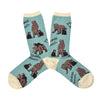 A pair of womens light blue socks with a cream heel, toe and, cuff. They have all over print of brown mother bears and their young with little pink hearts and, cursive script that reads "Mama Bear".