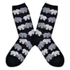 Shown in a flatlay, a pair of women's Socksmith brand cotton crew socks in black with an all over design of 2 elephants linking trunks with a little red heart between them.