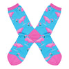 Shown in a flatlay, a pair of women's Socksmith brand cotton crew socks in light blue with a pink heel, toe, and cuff. The sock features one legged pink flamingos all over.