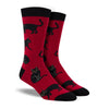 Shown on a leg form, these red bamboo men's crew socks with a black heel, toe and cuff by Socksmith feature black cats lying, sitting and walking.