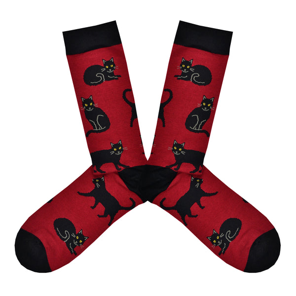 These red bamboo men's crew socks with a black heel, toe and cuff by Socksmith feature black cats lying, sitting and walking.