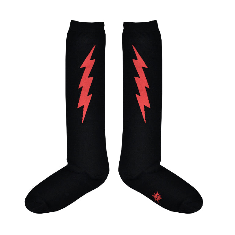 Shown in a flatlay, a pair of Sock It To Me cotton knee high socks in black with a large red thunderbolt on each side