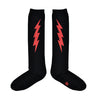 Shown in a flatlay, a pair of Sock It To Me cotton knee high socks in black with a large red thunderbolt on each side