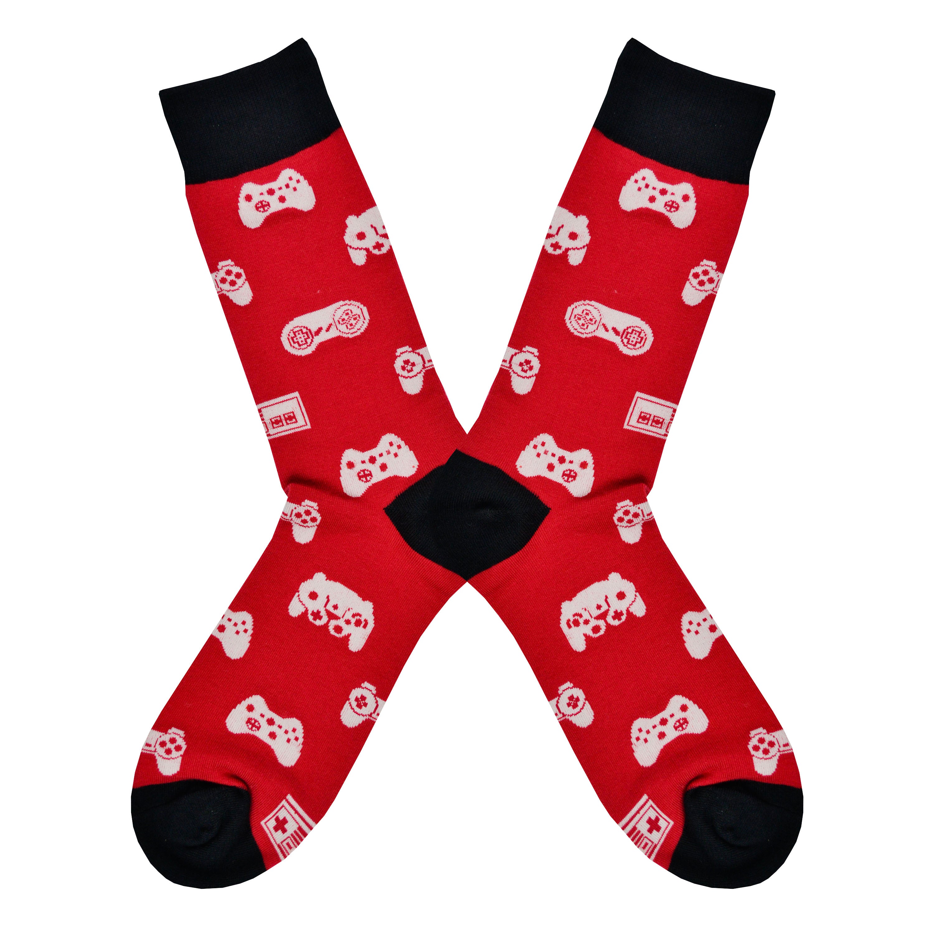 Shown in a flatlay, a pair of Sock it to Me brand men's cotton crew socks in red with a black heel, toe, and cuff. These socks feature various vintage game controllers in white all over the sock.
