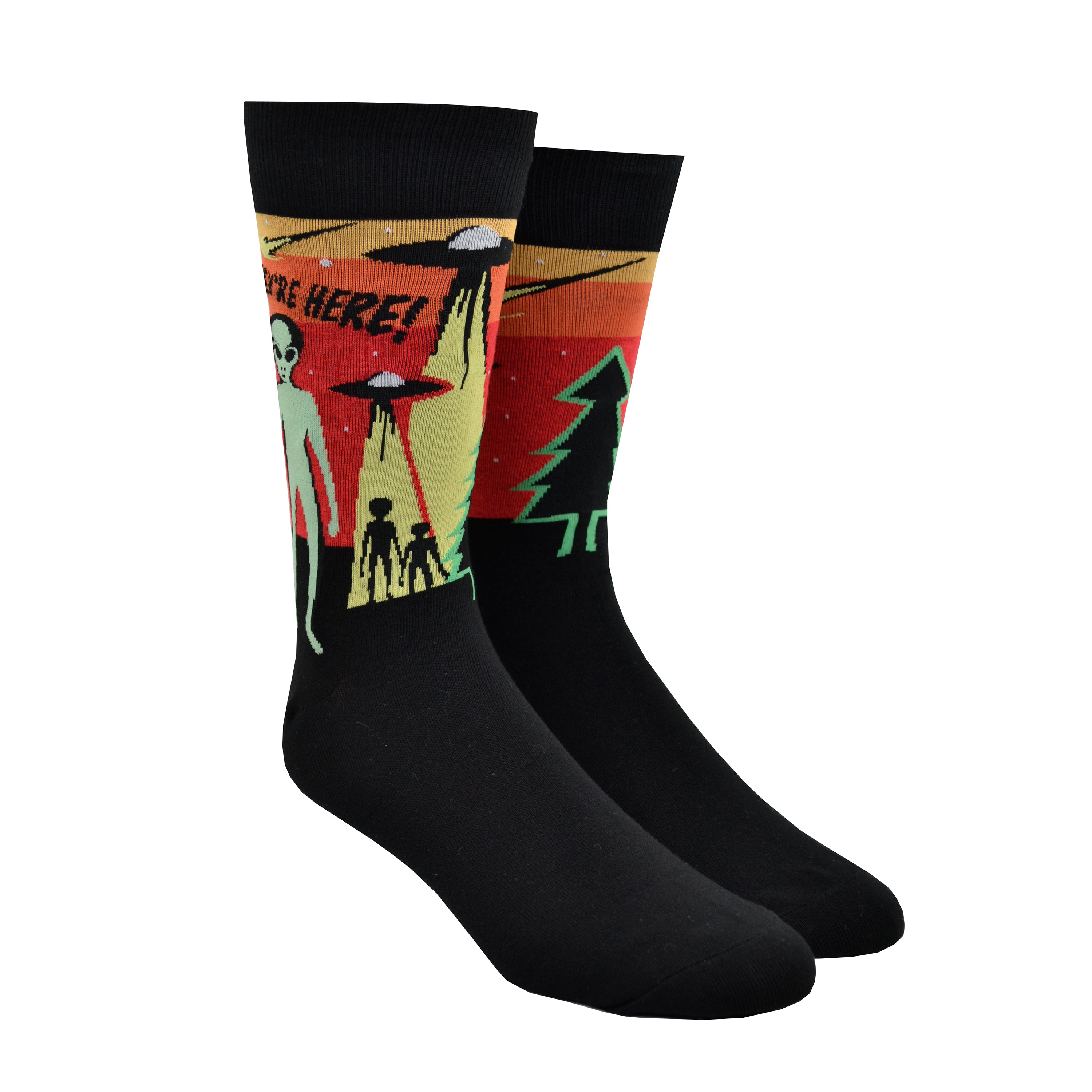 Shown on foot forms side by side, a pair Sock It to Me cotton men's crew socks in black with a yellow, orange, and red background on the leg featuring a green alien and 2 space ships. The text on the sock reads, 