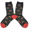 Shown in a flatlay, a pair of women's Sock it to Me cotton sparkle crew socks in black with a red heel and toe and an all over glitter rainbow motif.