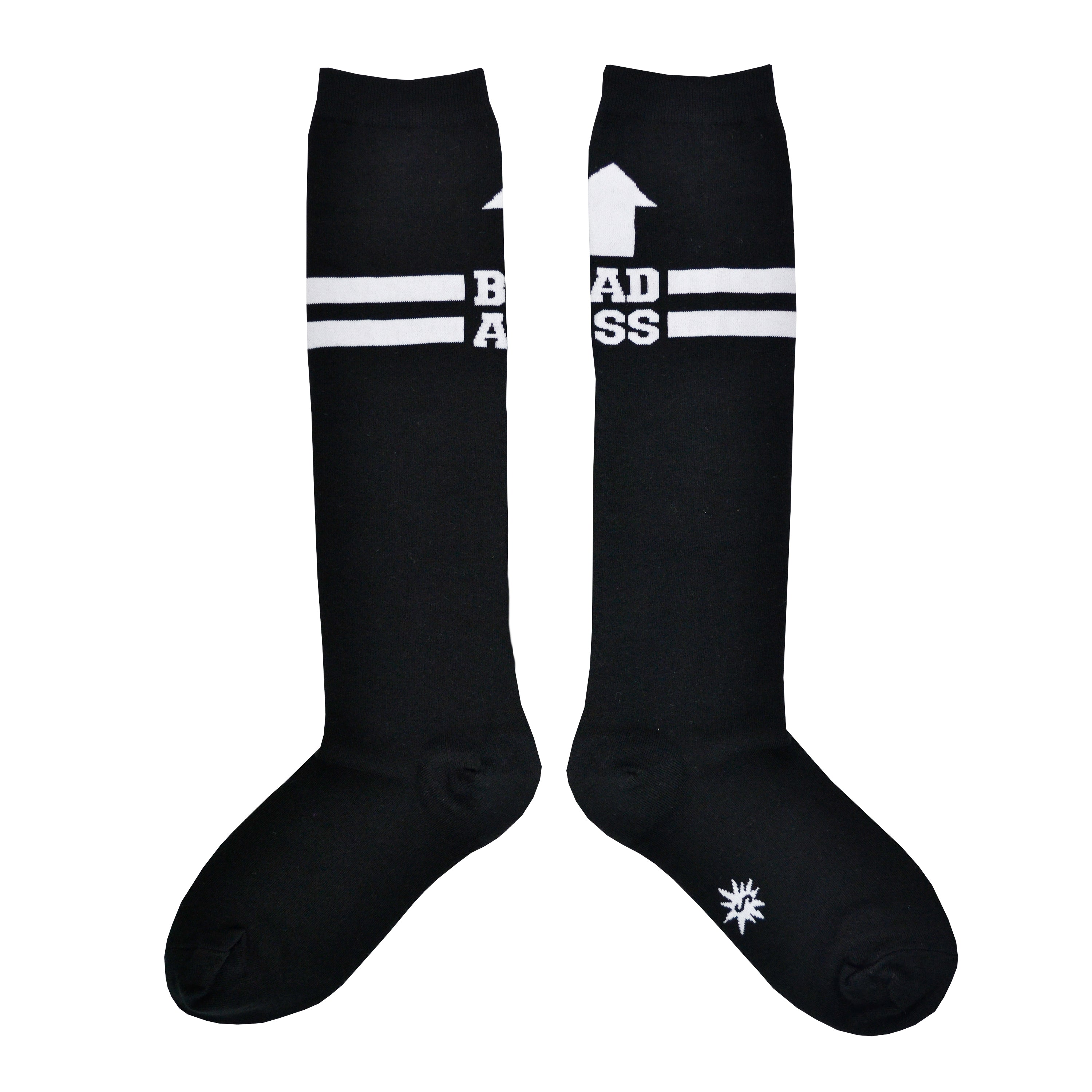 Shown in a flatlay, a pair of Sock It To Me brand unisex cotton knee high socks in black with two white stripes around the calf. the back of the sock features a white arrow pointing up to the wearer and says, 