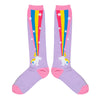 Shown in a flatlay, a pair of Sock it to Me brand unisex cotton knee high socks in lilac with a pink heel, cuff, and toe. The sides of this sock feature a cartoon unicorn farting a magical rainbow that goes up the sock.