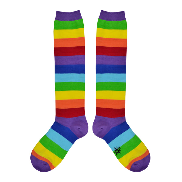 Shown in a flatlay, a pair of Sock it to Me brand Stretch-It cotton knee high socks with an all around rainbow stripe. The heel, toe, and cuff are done in purple while the red of the sock is classic ROYGBIV rainbow.