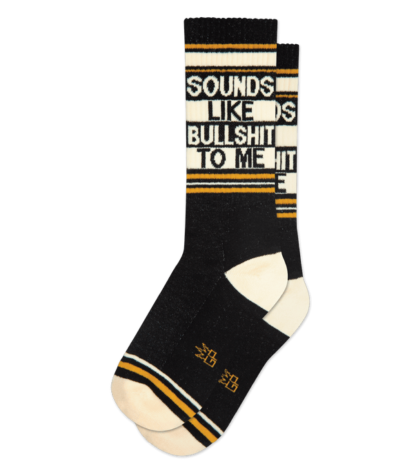 a .png of a pair of black socks with ivory toe and heel, orange stripe details and ivory text that says "sounds like bullshit to me"