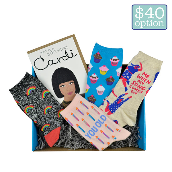 A cute surprise box with various socks and cards with a birthday theme