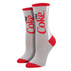 Shown on leg forms, a pair of Socksmith brand women's cotton crew socks in grey with a red heel, toe, and cuff. The leg of the sock features the iconic Diet Coke Logo.