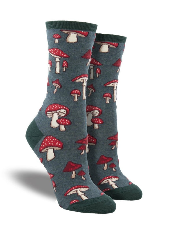 Shown on a leg form, these heather green cotton women's crew socks by the brand Socksmith feature cute little mushrooms with red caps and white spots.