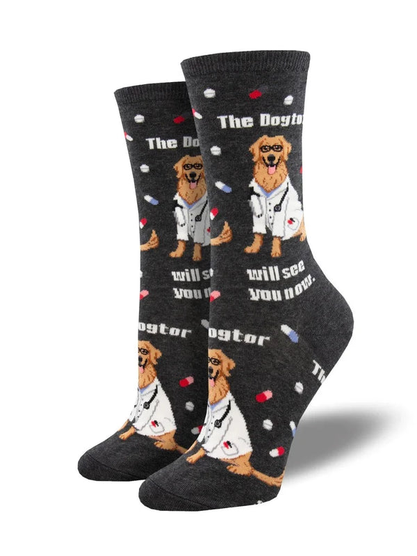 leg forms displaying a pair of charcoal gray socks featuring a golden retriever wearing a white lab coat and small pills and capsules with the text "the dogtor will see you now."
