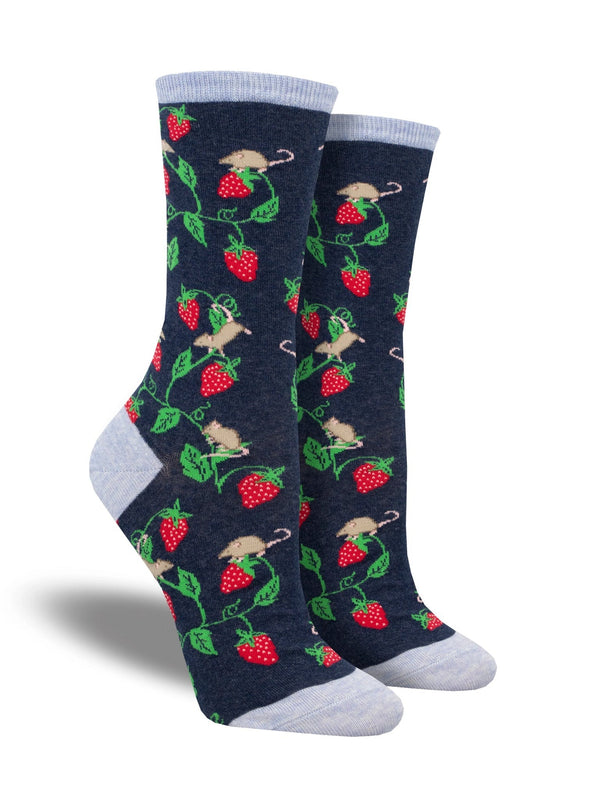 Shown on leg forms, a pair of women's fit Sock Smith brand cotton crew socks in navy blue. They have a light blue heel, toe, and cuff with an all over design of strawberry vines and little brown mice. 