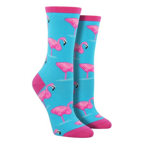 Shown on leg forms, a pair of women's Socksmith brand cotton crew socks in light blue with a pink heel, toe, and cuff. The sock features one legged pink flamingos all over.