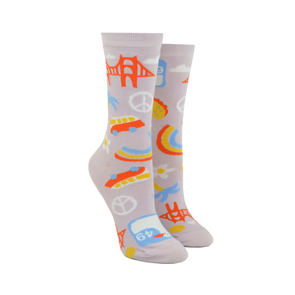 Shown on leg forms, a pair of women's Yellow Owl Workshop cotton and nylon crew socks in lilac. These socks feature iconic San Francisco imagery like the golden gate bridge, peace signs, VW vans, seagull signage, and flower power.