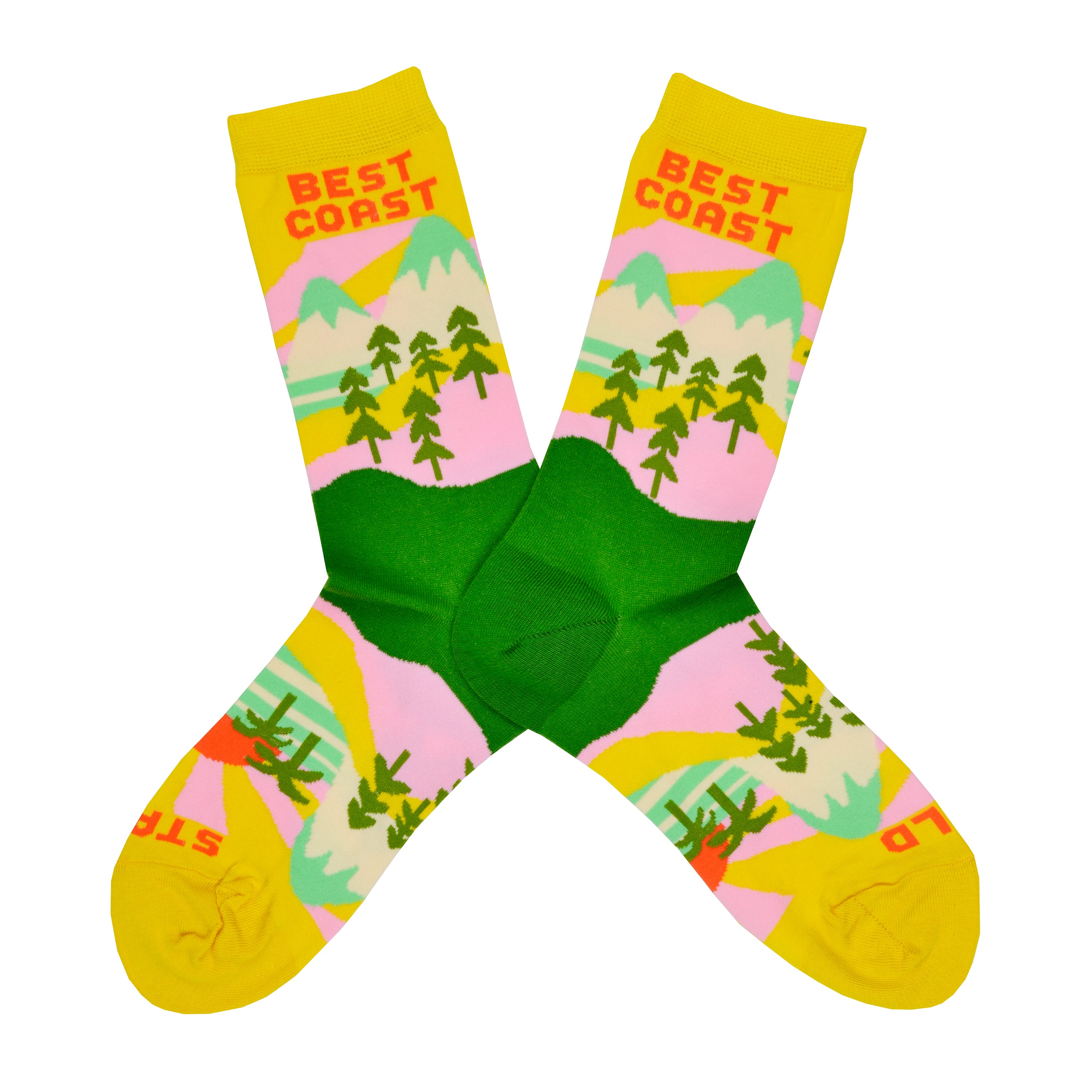 These yellow cotton women's novelty crew socks by the brand Yellow Owl Workshop feature green trees, teal and white mountains, and pink clouds and say the words 