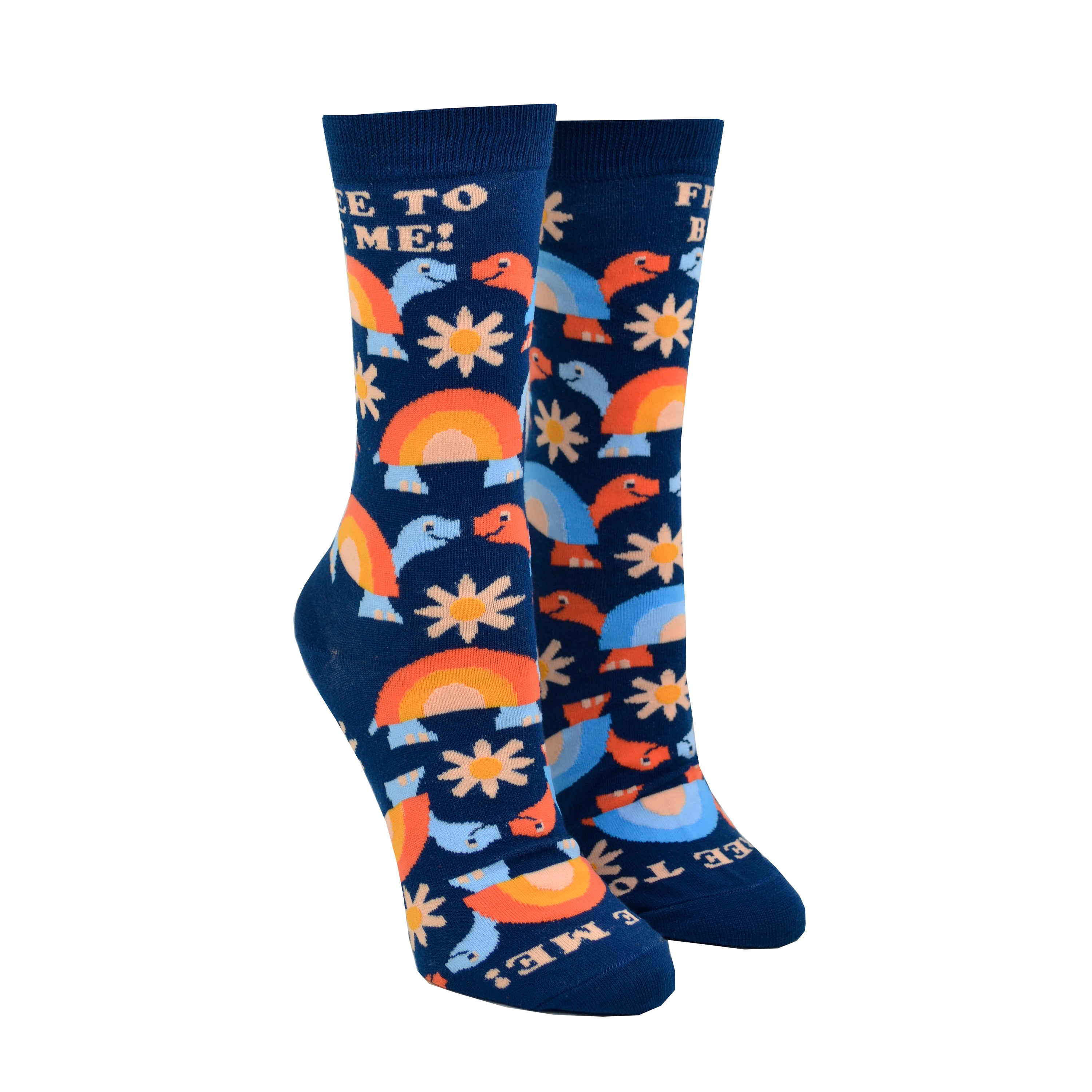 Shown on leg forms, a pair of women's Yellow Owl Workshop brand cotton and nylon socks in navy blue with orange and blue rainbow shelled turtles and orange daisies and the words 