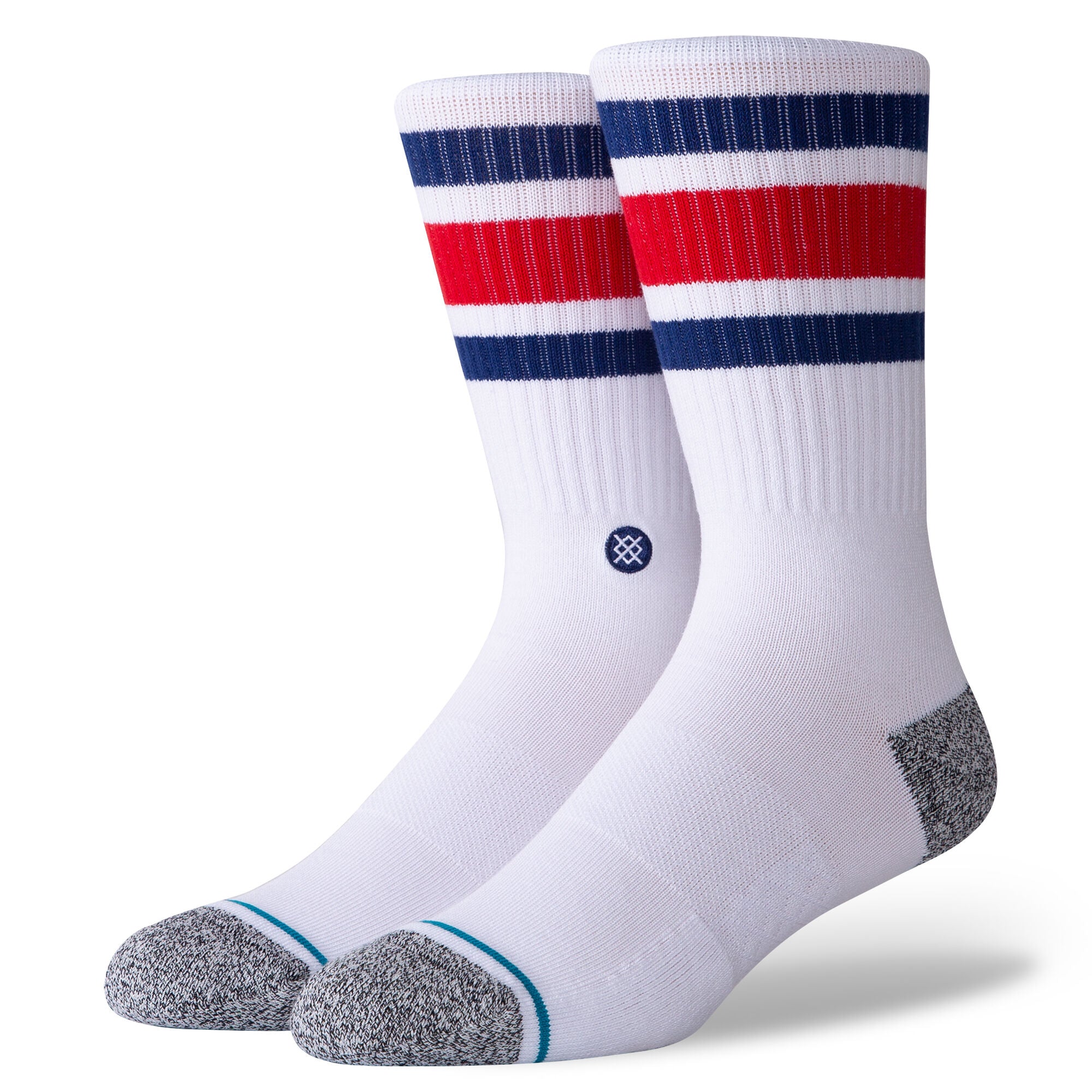 a white pair of crew length socks modeled on a foot form with a grey toe and heel and a blue, red, blue striped pattern near the cuff