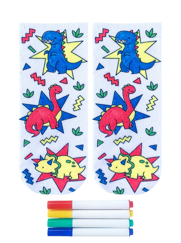 white socks with a dinosaur print that has been colored in primary colors with four fabric markers displayed below
