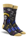 Shown on a leg form, a pair of Socksmith's bamboo men’s crew socks with mustard-yellow cuff/heel/toe and a spooky skeleton woman with a Madonna halo