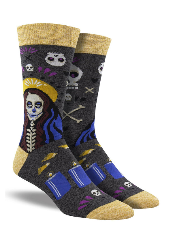 Shown on a leg form, a pair of Socksmith's bamboo men’s crew socks with mustard-yellow cuff/heel/toe and a spooky skeleton woman with a Madonna halo