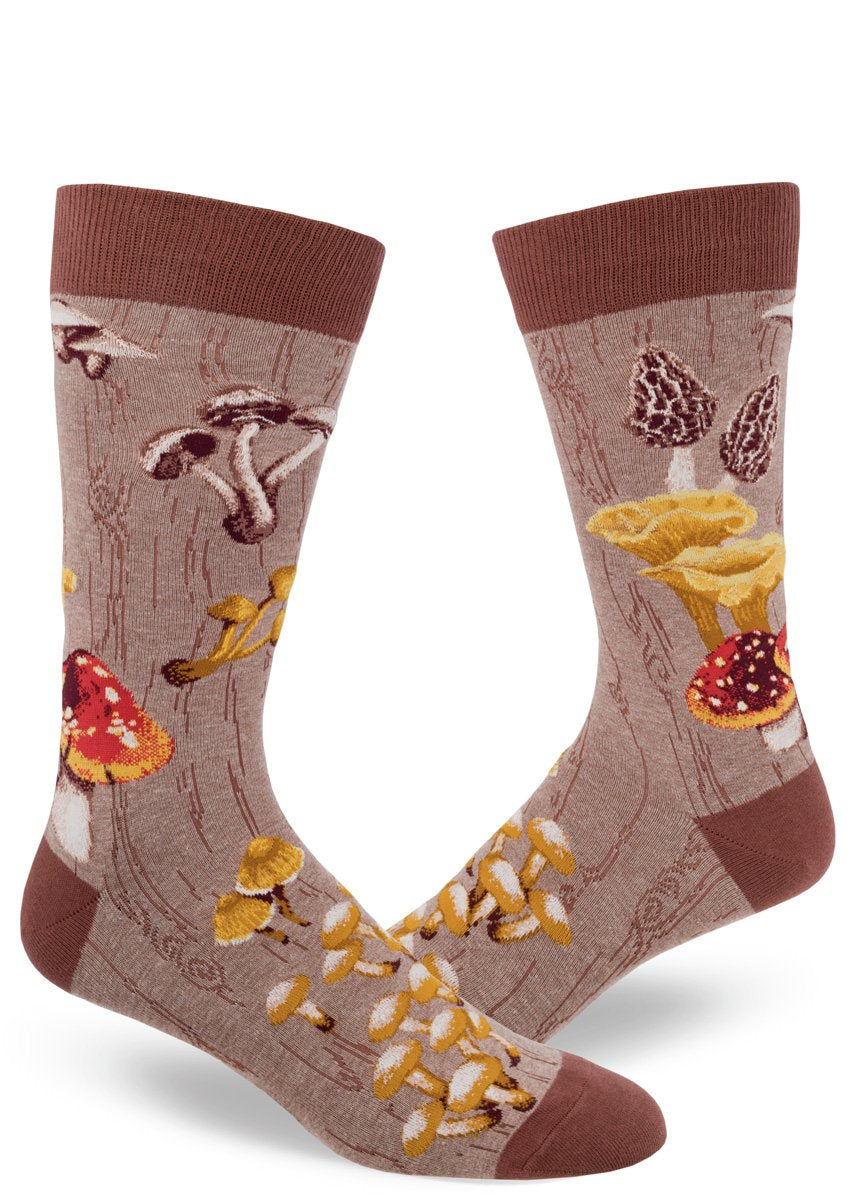Shown on a foot form in a different angle, a pair of Mod Socks’ brown cotton men's crew socks with a large design of different kinds of mushrooms